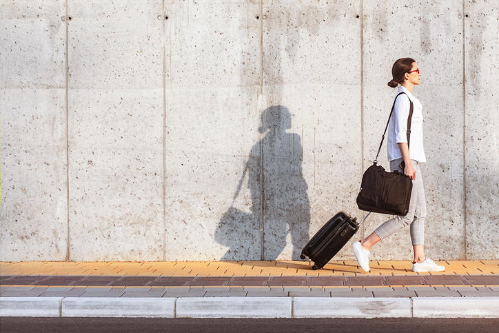 person walking with a suitcase